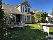 Charming two-story home with landscaped yard, front patio, and inviting curb appeal at 13474 W 65Th Dr, Arvada, CO 80004