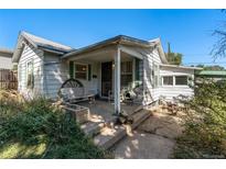 Charming cottage-style home featuring a welcoming front porch and quaint architectural details at 2862 S Grant St, Englewood, CO 80113