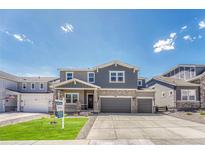 Charming two-story home featuring a well-manicured lawn and a spacious two-car garage at 3008 Blithe Pt, Castle Rock, CO 80108