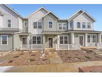 Two-story townhome with light green siding, white trim, and a small front yard at 1926 S Haleyville Way, Aurora, CO 80018