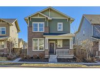 Charming two-story home with a brick facade and a cozy front porch at 2572 Iola St, Aurora, CO 80010