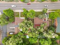 Aerial view of a property with mature trees next to a busy thoroughfare at 25 S Wadsworth Blvd, Lakewood, CO 80226