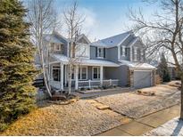 Inviting two-story home showcasing a charming front porch and meticulously maintained landscaping at 6290 Virgil St, Arvada, CO 80403