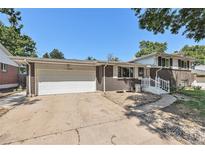 Charming brick home featuring an attached two-car garage and well-kept front yard at 1533 S Jamaica St, Aurora, CO 80012