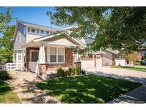 Charming two-story home with a well-maintained front lawn and brick accents at 24749 E Florida Ave, Aurora, CO 80018