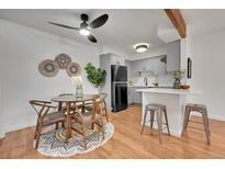 Modern kitchen features gray cabinetry, stainless steel appliances, and an adjacent dining area at 201 Wright St # 105, Lakewood, CO 80228