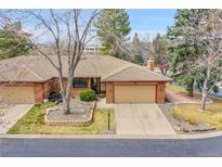 Charming brick home with a well-maintained lawn, mature trees and a two-car garage at 8040 W 78Th Way, Arvada, CO 80005