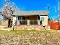 Charming single-story home featuring a quaint porch and brick accents at 2561 W Dartmouth Ave, Denver, CO 80236