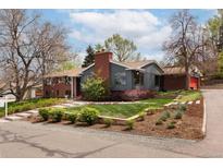 Charming single-Gathering home featuring a well-manicured lawn and a combination of brick and siding exterior at 26 Morningside Dr, Wheat Ridge, CO 80215