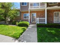 Inviting brick and siding townhouse with well-maintained lawn and garden at 4574 S Cimmarron Cir # B, Aurora, CO 80015