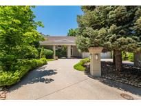 Stunning single-story home with a lush landscaped front yard and circular driveway at 400 S Steele St # 13, Denver, CO 80209