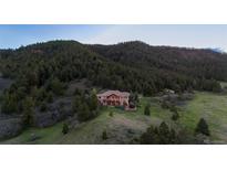 Secluded mountain estate featuring mature trees, open meadows, and stunning mountain views at 15533 S Perry Park Rd, Palmer Lake, CO 80133