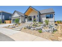 Beautiful, modern home with professional xeriscaping and inviting concrete stairway to a covered porch entry at 1148 Hillside Ln, Louisville, CO 80027