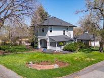 Charming two-story home featuring a well-manicured lawn and inviting front porch at 5801 W 33Rd Ave, Wheat Ridge, CO 80212