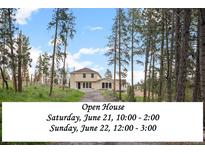 Charming two-story home nestled among tall trees with inviting open house this weekend at 27987 Pine Grove Trl, Conifer, CO 80433