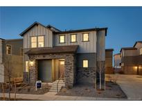 Charming two-story home with stone accents, well-manicured landscaping, and an inviting entrance at 23990 E 41St Ave, Aurora, CO 80019