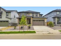 Charming two-story home featuring stone accents, a two car garage, and professionally landscaped front yard at 7440 S Yank Ct, Littleton, CO 80127