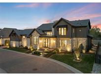Elegant two-story home with a stone and gray exterior, professionally landscaped front yard, and inviting entrance at 2821 E Cedar Ave # 2, Denver, CO 80209
