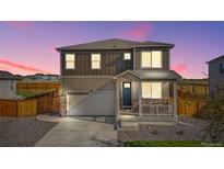 Charming two-story home featuring stone accents, a covered front porch, and a well-maintained landscaped yard at 4125 Marble Dr, Longmont, CO 80504