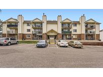 Spacious condo building featuring private balconies, brick accents and ample parking at 481 S Kalispell Way # 205, Aurora, CO 80017