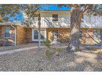 Updated brick front exterior of townhome with landscaping and walkway at 10330 E Jewell Ave # 67, Aurora, CO 80247