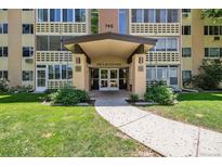 Exterior view of building entrance with covered walkway and well-manicured lawn at 745 S Alton Way # 11A, Denver, CO 80247