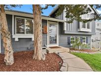Charming home featuring a welcoming front entrance with meticulous landscaping and a cozy walkway at 5870 S Perth Pl, Centennial, CO 80015
