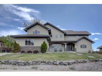 Stunning home featuring a beautiful stone accent and manicured front yard at 14993 W 55Th Dr, Golden, CO 80403