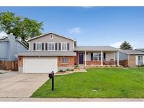 Charming two-story home with a well-manicured front yard and a two-car garage in a suburban setting at 11021 Otis St, Westminster, CO 80020