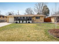 Charming home featuring a well-maintained lawn and an inviting enclosed porch at 169 Emerald St, Broomfield, CO 80020