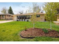 Charming ranch-style home featuring a well-manicured lawn and mature trees, set in a serene neighborhood at 169 Emerald St, Broomfield, CO 80020
