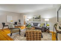 Inviting living room with hardwood floors and designer furnishings at 169 Emerald St, Broomfield, CO 80020