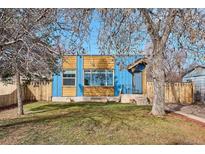 Charming home with a well-maintained front yard, mature trees, and blue painted exterior at 1937 Jay St, Lakewood, CO 80214