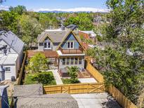Beautifully landscaped backyard featuring a pergola, hot tub, patio and privacy fence at 4348 Umatilla St, Denver, CO 80211
