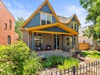 Charming two-story home with a landscaped front yard and inviting front porch at 4348 Umatilla St, Denver, CO 80211