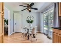 Bright breakfast nook featuring a glass table with seating for four and sliding glass door access to the backyard at 13483 Achilles Dr, Lone Tree, CO 80124