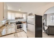 Galley kitchen featuring stainless steel appliances and granite countertops at 5491 E Warren Ave # 224, Denver, CO 80222