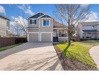 Charming two-story home with a well-maintained lawn and a two car garage at 9687 Timbervale Ct, Highlands Ranch, CO 80129