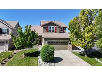Charming two-story home featuring a well-manicured lawn and mature trees in a desirable neighborhood at 9255 Melborne Ct, Parker, CO 80134