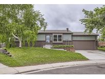 Charming single-story home with brick accents, landscaped front yard, and an attached two-car garage at 10602 W Patterson Pl, Littleton, CO 80127