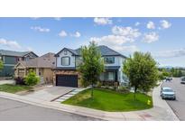 Beautiful two-story home featuring a well-manicured lawn and attached garage at 5021 S Rome St, Aurora, CO 80015