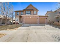 Beautiful two-story home featuring a brick facade and attached two car garage at 5128 Longs Peak St, Brighton, CO 80601