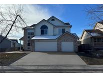 Charming two-story home with brick accents and a spacious two car garage at 11716 W Belleview Dr, Littleton, CO 80127