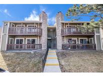 Inviting condo exterior featuring stone accents, private balconies, and well-maintained landscaping at 3412 S Eagle St # 202, Aurora, CO 80014