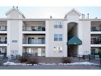 Three story condo building with balconies and an elevated walkway to the units at 12158 W Dorado Pl # 204, Littleton, CO 80127