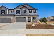 Charming two-story home with a gray exterior, a two-car garage, and a welcoming front porch at 6636 N Nepal St, Aurora, CO 80019