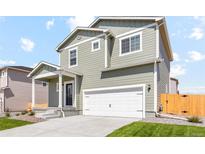 Charming two-story home with a two-car garage, a covered entry, and well-manicured landscaping at 7330 Green River Ave, Frederick, CO 80530