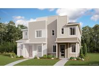Modern townhome with varied siding, manicured landscaping, and inviting entryway, offering a contemporary living space at 4594 S Versailles St # B, Aurora, CO 80015