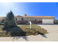 Charming single-story home with well-maintained front yard and attached two-car garage at 10942 W 107Th Pl, Broomfield, CO 80021