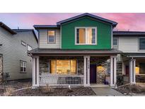 Charming two-story home with a welcoming front porch and colorful exterior at 21538 E 59Th Pl, Aurora, CO 80019